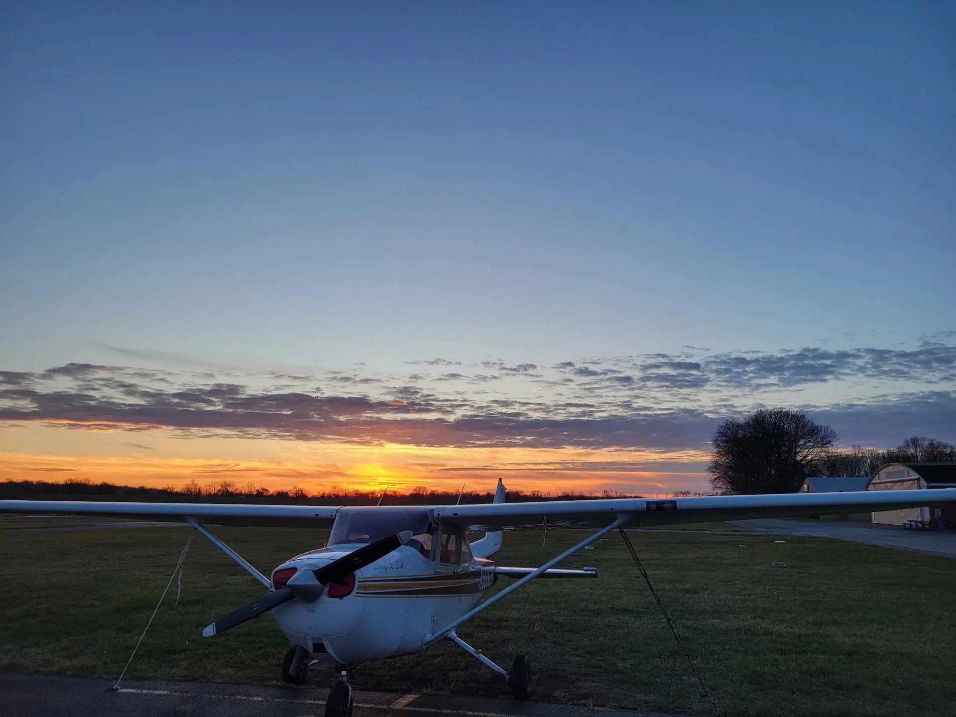 Airplane on runway sunset in the background