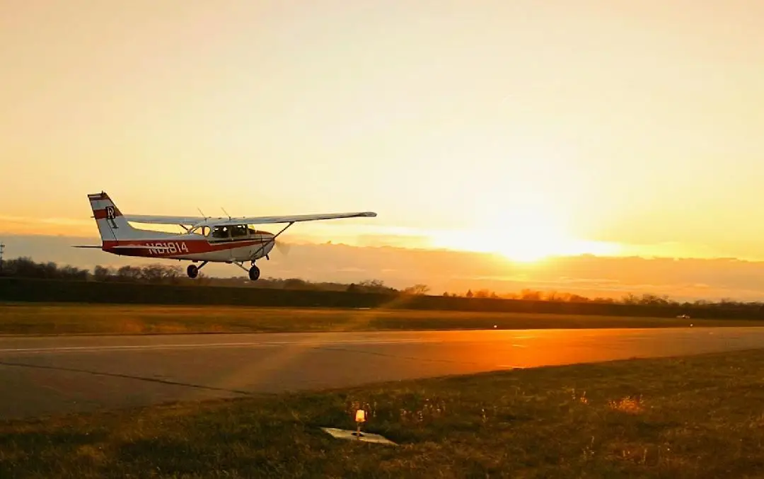 Airplane taking off at sunset