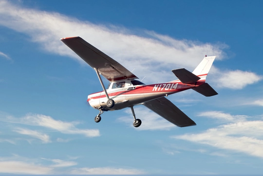 Low-angle view of an airplane flying near Dayton Aviation Services